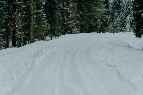 Snowy icy road. Danger of winter travel by road from ice