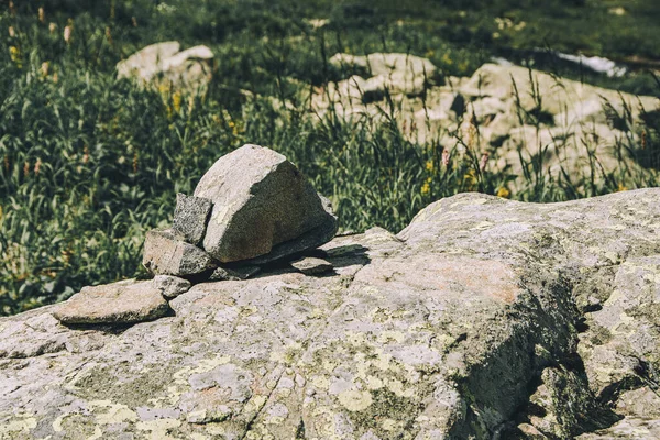 Pile of rocks, stones markers  for orientation in area. Travel through mountain valley. Hill of stones for meditation in nature.