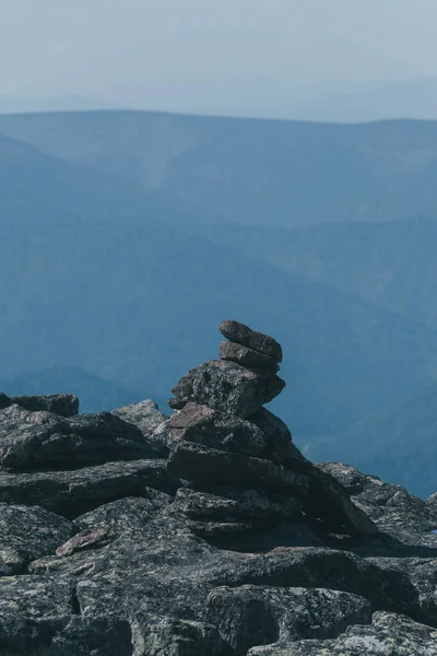 Pile of rocks, stones markers  for orientation in area. Travel through mountain valley. Hill of stones for meditation in nature.