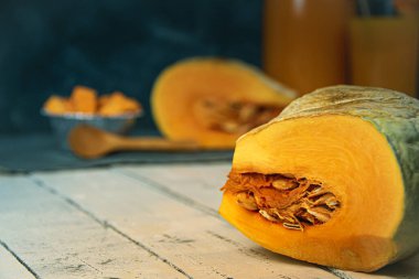 Pieces of pumpkin with seeds on table. Farmer autumn harvest. Cooking vegetable dishes. Vegetarian fair. Gardening, growing healthy food yourself for hobbies