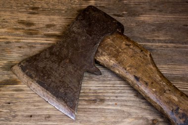 Old ax on a wooden background. top view.