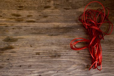 Red Rope and Textured Wood, Coil  set against highly textured wood.