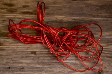 Red Rope and Textured Wood, Coil  set against highly textured wood.