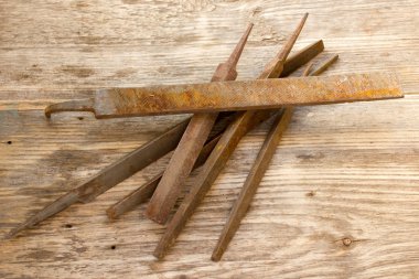 Various different steel retro rusty rasp file tool collection isolated on wooden background