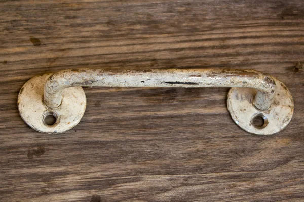 Metal rusty door handle on wood background — Stock Photo, Image