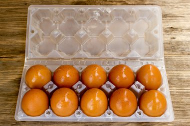 Eggs in box on a wooden table