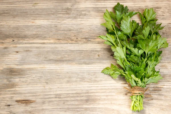 Bunch of parsley tied with rope, on old wooden board — Stok fotoğraf