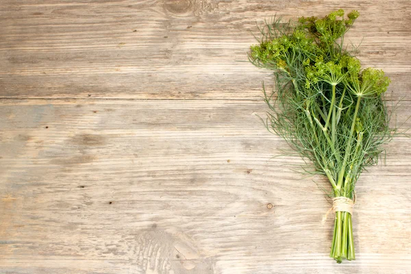 Fresh dill sprigs on wooden. Copy space to right. — ストック写真