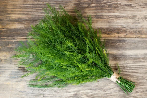 Dill on wooden table — Stock Photo, Image