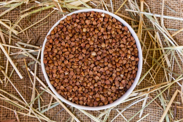 Buckwheat on burlap background texture — Stock Photo, Image