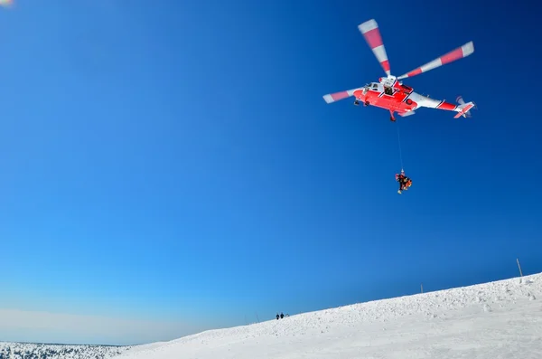 A rescue helicopter is in mountains