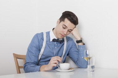 Disappointed man stirring coffee clipart