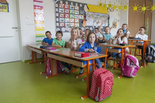 Schoolchildren in a classroom — Stock Photo, Image