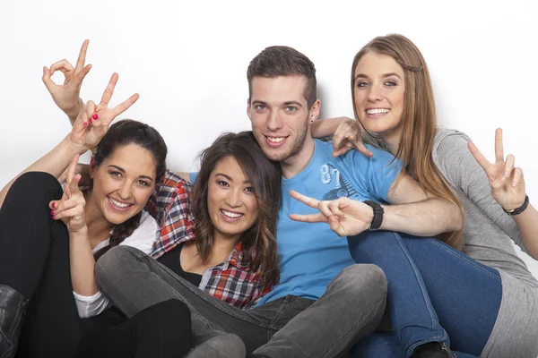 Four teenagers show victory gesture — Stock Photo, Image