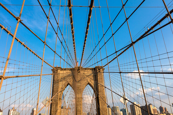 The Brooklyn Bridge is a hybrid cable-stayed/suspension bridge in New York City and is one of the oldest bridges of either type in the United States. Completed in 1883, it connects the boroughs of Manhattan and Brooklyn by spanning the East River. It
