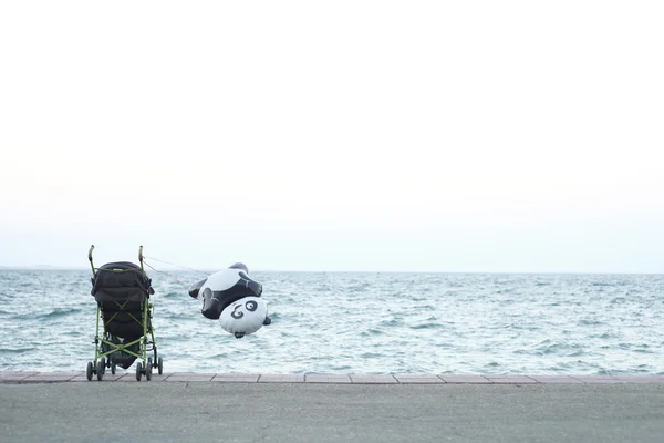 Baby carriage on the embankment — Stock Photo, Image