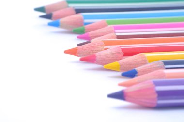 Sıraya dizilmiş çeşitli renkli tahta kalemler.