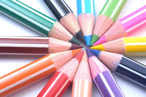 Various colored wooden pencil crayons placed in a row