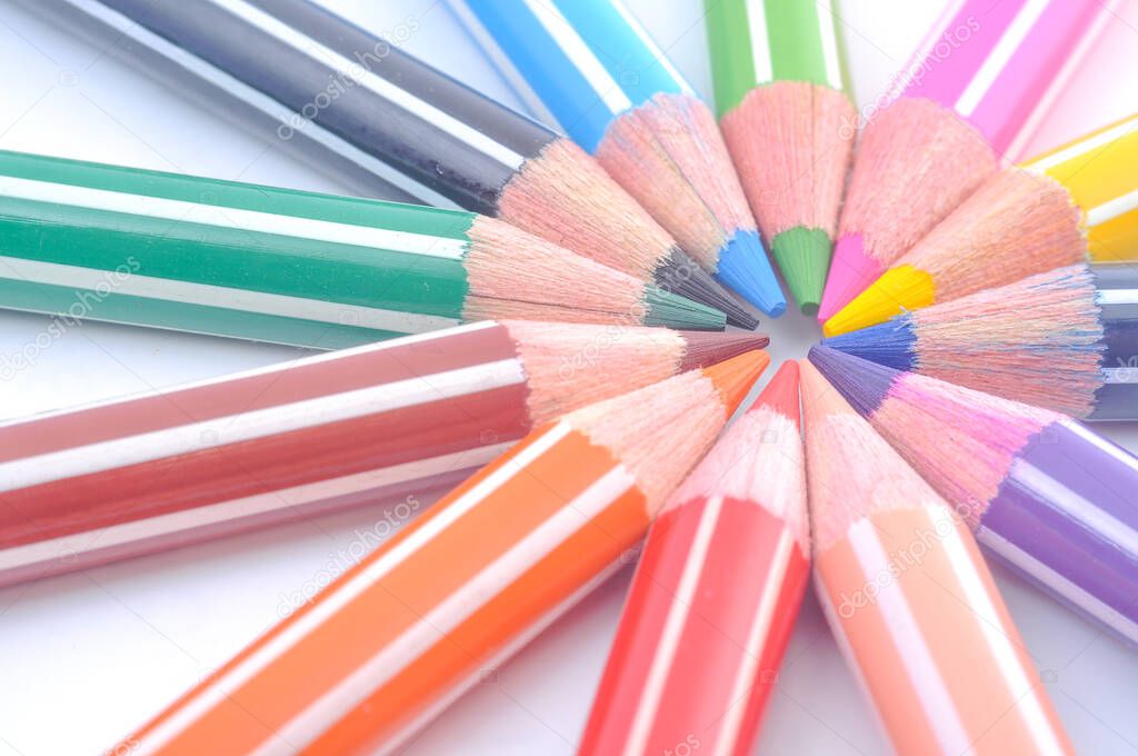 Various colored wooden pencil crayons placed in a row