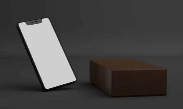 茶色の革の箱の横にグレーの背景にライト付きの画面を持つ携帯電話 — ストック写真