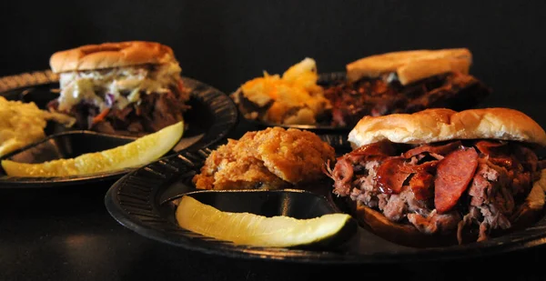 Pulled-Pork Sandwich, Ribs with Baked Beans and a Brisket Sandwich topped with Pork Hot Lin