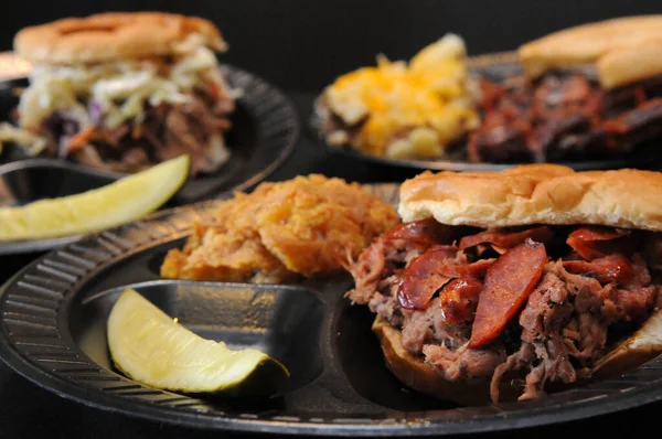 Pulled-Pork Sandwich, Ribs with Baked Beans and a Brisket Sandwich topped with Pork Hot Lin