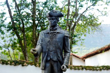 Tiradentes, Minas Gerais, Brazil - February 20, 2021: Tiradentes metal statue representing the young ensign on a public road clipart