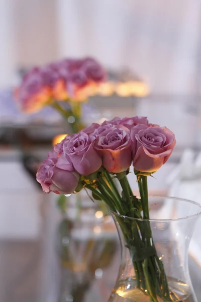 Jar with purple roses — Stock Photo, Image