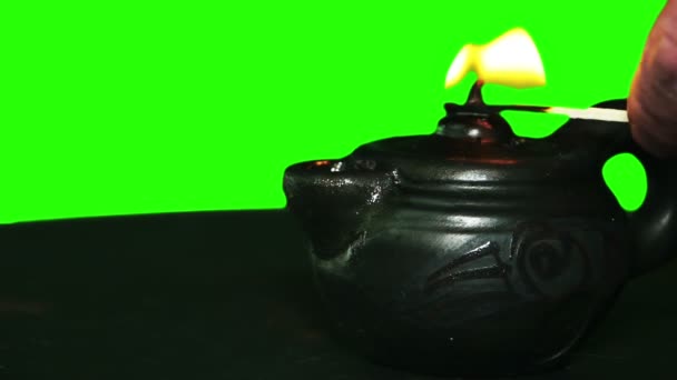 Oil lamp are branded with a match. Green screen. Close-up. — Stock Video
