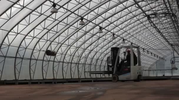 Forestry. Tractor - lift working in the greenhouse — Stock Video