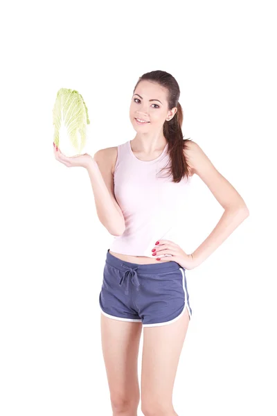 Beautiful young woman smiling while holding a cabbage — Stock Photo, Image