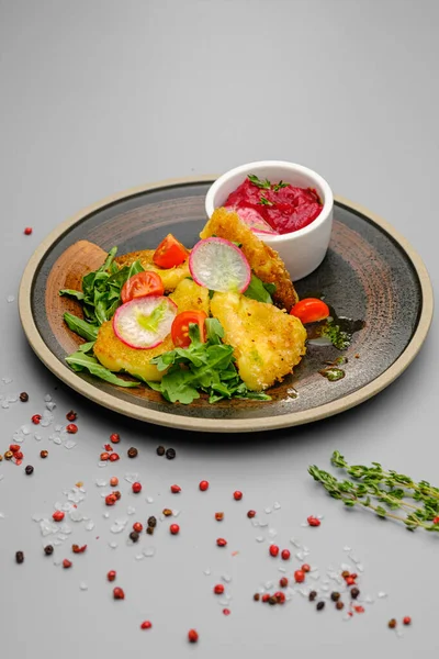 Fried french fries breaded with greens, radishes and beet chips on a white plate. — Stock Photo, Image