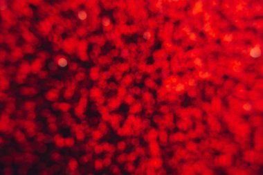 Soyut, parlak, bulanık, kırmızı arkaplan. Projeleriniz için desenli, ışıltılı bir fon. Boşluğu kopyala