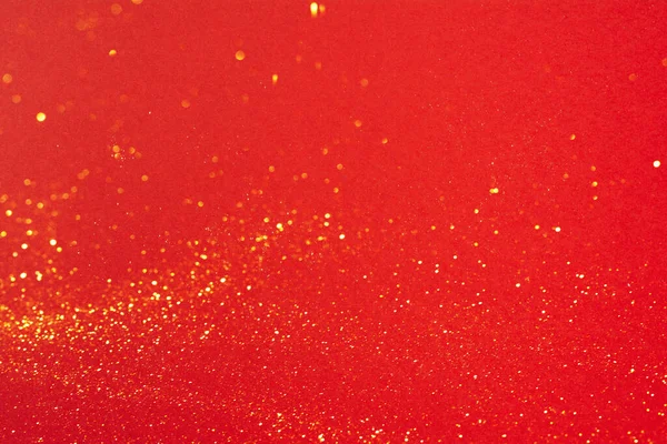 Mały złoty brokat na jasnoczerwonym tle — Zdjęcie stockowe