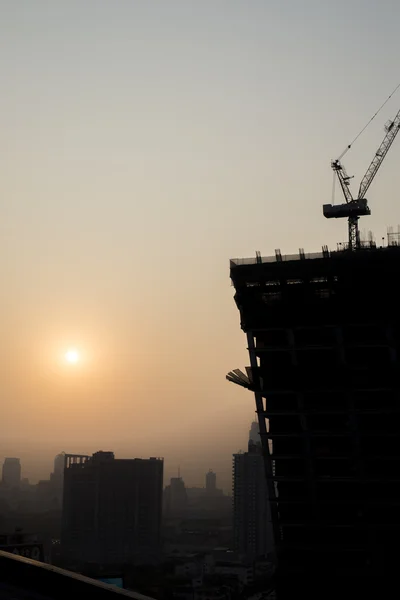 Background: Sunset with the building construction