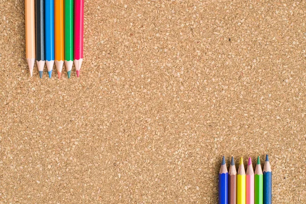 Colour pencils on cork board background close up — Stock Photo, Image