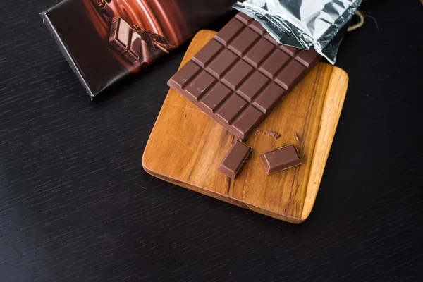Pack of Dark chocolate bar on the cutting board