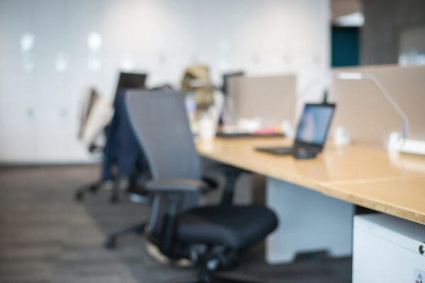 Abstract office blur background with wooden desk, chair with lap