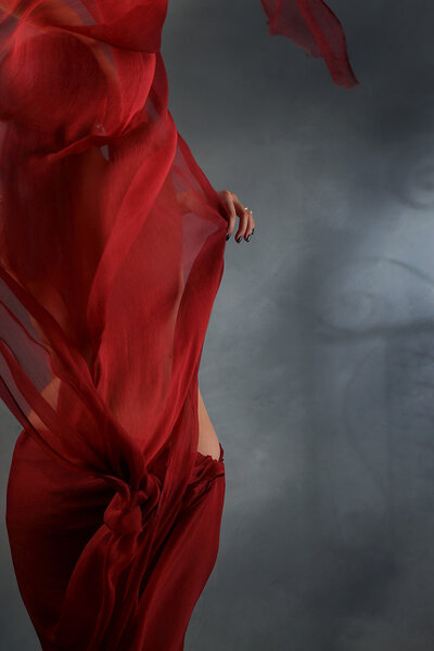 Girl with red silk fabric
