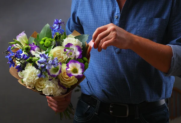 a man with a blue bouquet