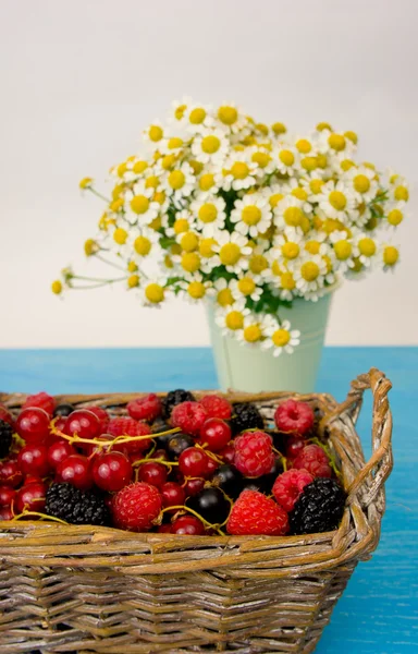 Mix of fresh berries in a basket on rustic wooden background — Stock Photo, Image