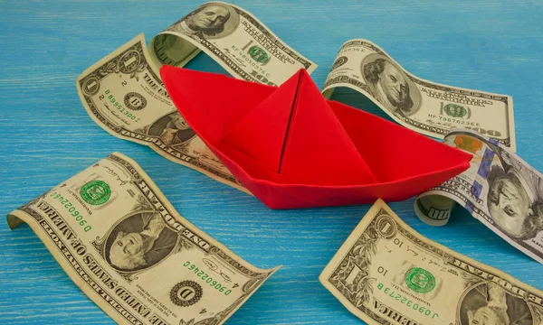 Origami paper boat at sea of money / american moneys of hundred — Stock Photo, Image