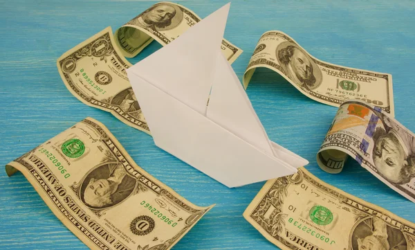 Paper ship sails on waves of money / dollars — Stock Photo, Image