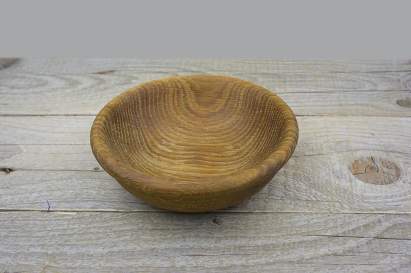 Empty bowl on old wooden surface. Closeup. — Stock Photo, Image