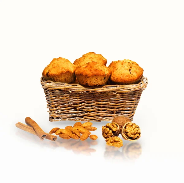 Muffins in a basket with nuts, almonds and cinnamon — Stock Photo, Image