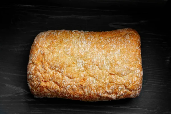 Fresh homemade bread isolated on black background. Top view chiabatta. — Stock Photo, Image