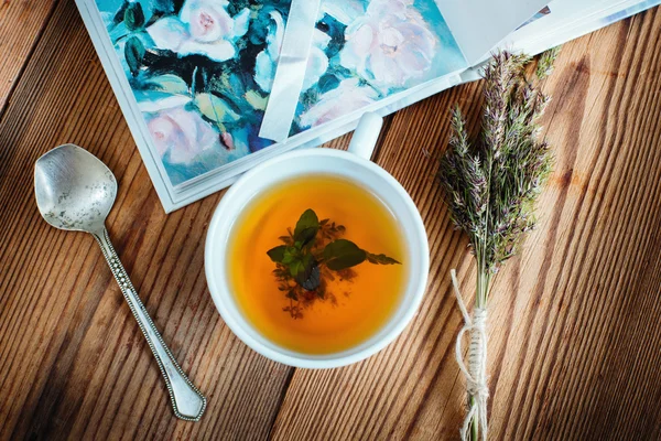 Tea herbs with spoon and book