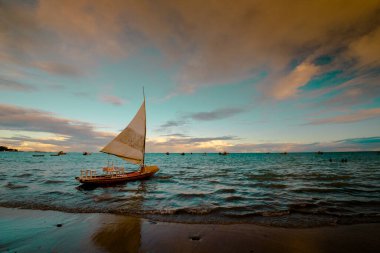 Sunset and tourist boats on a beach in Maceio, Brazil