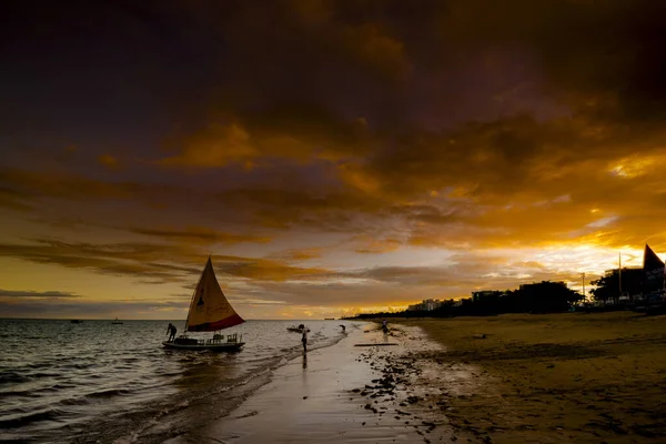 Sunset and tourist boats on a beach in Maceio, Brazil