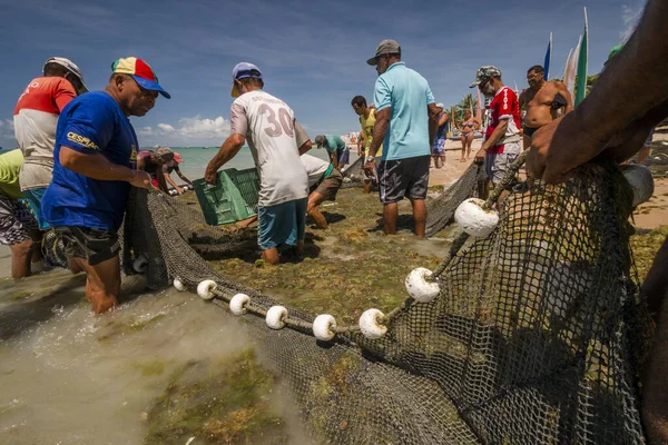 Fishermen working on a beach in Maceio, Brazil